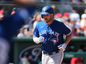 Toronto Blue Jays first haseman Travis Shaw (6) scores after hitting a home run against the Boston Red Sox at Spring Training in March. Shaw isn't sure a season can happen in blazing Arizona.