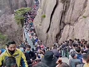 An estimated 20,000 people packed a popular tourist spot after the Chinese government eased some restrictions. TWITTER