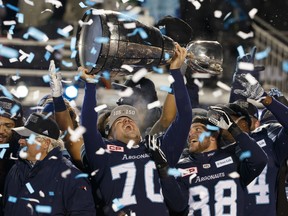 Lirim Hajrullahu #70 of the Toronto Argonauts raises the Grey Cup after winning the 105th Grey Cup in 2017. Hajrullahu is hoping to live his NFL drea, after signing a deal with Los Angeles, but will have to wait until the pandemic is over to try out.