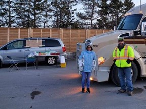 Ryan Hill, right, serving free food to truckers in Sault Ste. Marie, Ont. on Friday, April 10 2020