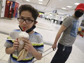 Ken Abbasi and his son Ibrahim, 10, of Edmonton, flew home from Lahore, Pakistan, with help from the Canadian High Commission and stopped over at Toronto's Pearson International Airport on Thursday, April 2, 2020. (Jack Boland/Toronto Sun/Postmedia Network)