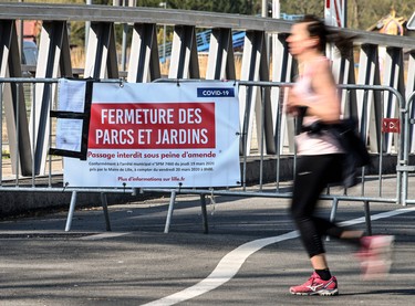 A jogger runs past a sign alerting citizens that the Citadel Park of Lille is closed due to the Covid 19 pandemic on April 8, 2020,  on the twenty-three day of a strict lockdown in France aimed at curbing the spread of the COVID-19 pandemic, caused by the novel coronavirus.  . (Photo by DENIS CHARLET / AFP) (Photo by DENIS CHARLET/AFP via Getty Images)