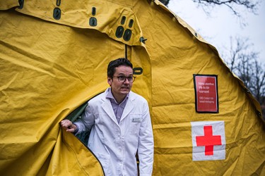 Hilmar Gerber, operations manager of the primary health clinic at Sophiahemmet hospital, steps out of a tent for testing and receiving potential coronavirus COVID-19 patients on April 7, 2020 in Stockholm. (Photo by Jonathan NACKSTRAND / AFP) (Photo by JONATHAN NACKSTRAND/AFP via Getty Images)