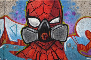 A graffiti by artist Kai 'Uzey' Wohlgemuth shows Spiderman wearing a protection mask on a wall in Hamm, western Germany, on April 8, 2020 refering to the spread of the novel coronavirus COVID-19. (Photo by Ina FASSBENDER / AFP) (Photo by INA FASSBENDER/AFP via Getty Images)