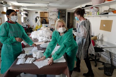 French seamstresses Jennyfer Flores (L), Patricia Hnizdo (C) and Aline Buffet (R) make protective face masks in the French Riviera city of Cannes, southern France, on April 08, 2020, on the twenty-third day of a strict lockdown in France to stop the spread of COVID-19 (novel coronavirus). (Photo by VALERY HACHE / AFP) (Photo by VALERY HACHE/AFP via Getty Images)