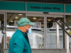 A paramedic wearing PPE (personal protective equipment) of face mask as a precautionary measure against COVID-19, stands outside of the Golden Jubilee Wing of King's College Hospital in London on April 29, 2020.