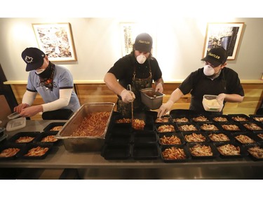 Michael Hunter (middle) co-owner of Antler restaurant on Dundas St. W. prepared 70 meals - traditional and veggie for the Respirology staff at St. Michael's Hospital. The meals included veggie pasta, a Venison pasta, salad, a sticky toffee dessert and juice. Thursday April 9, 2020. Jack Boland/Toronto Sun/Postmedia Network