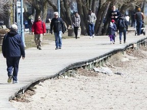 Torontonians enjoy a Friday afternoon in The Beach despite government calls for social distancing on Friday, March 27, 2020. (Stan Behal/Toronto Sun/Postmedia Network)