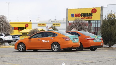 A pair of Beck Taxis sit idle on Thursday, April 16, 2020.