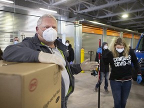 Ontario Premier Doug Ford and hockey legend Hayley Wickenheiser collecting donated medical supplies for Conquer COVID-19 on Saturday, April 11, 2020. (Stan Behal/Toronto Sun/Postmedia Network)