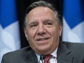 Quebec Premier Francois Legault smiles as he says he has no comments on the breach of confinement by Prime Minister Justin Trudeau over the Easter weekend, during a news conference on the COVID-19 pandemic, Tuesday, April 14, 2020 at the legislature in Quebec City.