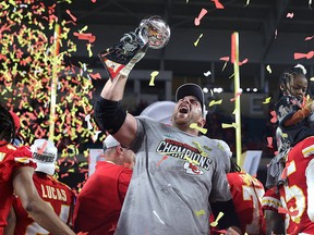 Laurent Duvernay-Tardif of the Kansas City Chiefs raises the Vince Lombardi Trophy after defeating the San Francisco 49ers 31-20 in Super Bowl LIV at Hard Rock Stadium on Feb. 2, 2020, in Miami.