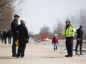 City officials look for Torontonians not abiding by new social-distancing directives at Woodbine Beach on Saturday, April 11, 2020. (Stan Behal/Toronto Sun/Postmedia Network)
