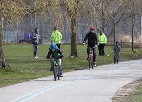 City officials look for Torontonians not abiding by new social-distancing directives at Woodbine Beach on Saturday, April 11, 2020. (Stan Behal/Toronto Sun/Postmedia Network)