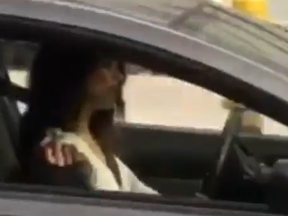 A driver gives the finger multiple times after she notices a person filming her while illegally stopped in a bike lane.