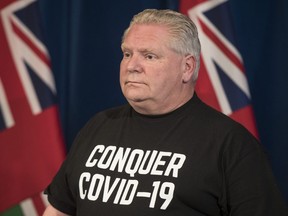 Ontario Premier Doug Ford updates the province on the fight to stop the COVID-19 pandemic while wearing a "Conquer COVID-19" T-shirt on Saturday, April 11, 2020. (Tijana Martin/Canadian Press)