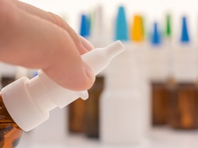 Spray head of a nasal spray with other cold sprays in the background