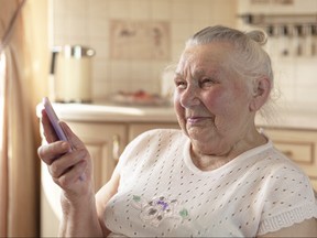 90 year old grandmother talking on a smartphone