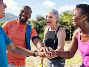 Mature people stacking hands after workout