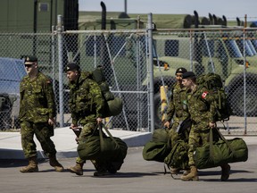 TORONTO, ON - APRIL 06: Members of the Canadian Forces head to their vehicles at Denison Armory to convoy to CFB Borden amid the spread of the coronavirus disease (COVID-19) on April 6, 2020 in Toronto, Canada. Troops will remain ready to respond to any requests made by any levels of government in Canada to help fight the pandemic. (Photo by Cole Burston/Getty Images)