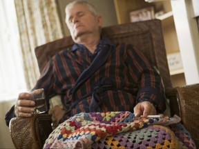 Man sleeping with drink and lit cigarette