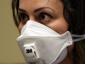 OAKLAND, CA - APRIL 28:  A nurse at the La Clinica San Antonio Neighborhood Health Center wears a N95 respiratory mask during a training session April 28, 2009 in Oakland, California. As the number of swine flu cases in the U.S. continues to rise, doctors and nurses at La Clinica's 26 facilities are being trained to use the N95 respiratory mask to be worn if they come in contact with a patient wo is suspected of having the swine flu or tuberculosis.  (Photo by Justin Sullivan/Getty Images)