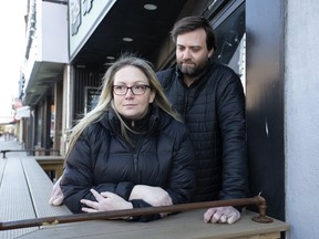 Ginger Robertson and her husband, Russ Douglas, in front of their Danforth Ave. business, The Edmund Burke pub, which they fear will not survive COVID-19.