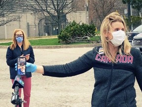 Hayley Wickenheiser at work at a warehouse, with actor Ryan Reynolds offering support on her cellphone. HANDOUT