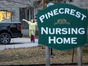 Workers wave at passing cars honking their horns in support for Pinecrest Nursing Home after several residents died and dozens of staff were sickened by coronavirus disease (COVID-19) in Bobcaygeon, Ontario, Canada March 30, 2020.