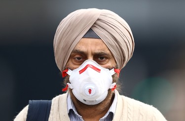 A man wearing a mask walks on Westminster bridge, as the spread of the coronavirus disease (COVID-19) continues, London, Britain, April 8, 2020. REUTERS/Hannah McKay ORG XMIT: AI