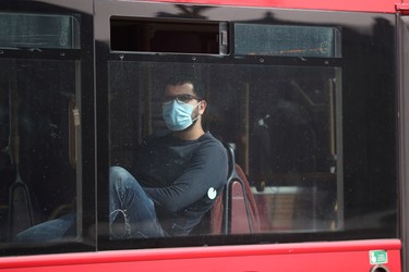 A passenger wearing a protective face mask is seen on as bus in London, as the spread of the coronavirus disease (COVID-19) continues, London, Britain, April 8, 2020. REUTERS/Hannah McKay ORG XMIT: AI