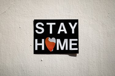 A placard which reads "Stay Home" is seen on a wall in Paris, during a lockdown imposed to slow the spread of the coronavirus disease (COVID-19) in France, April 8, 2020. REUTERS/Benoit Tessier ORG XMIT: PAR33