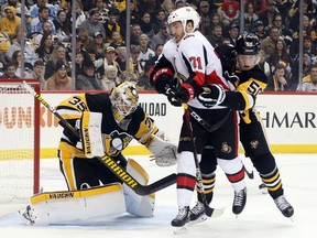 Pittsburgh Penguins goaltender Tristan Jarry and defenceman Juuso Riikola defend against Ottawa Senators centre Chris Tierney during the first period at PPG PAINTS Arena, Dec. 30, 2019..