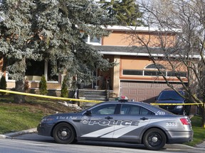 One day after a 79-year-old man — identified by family friends as retired oral surgeon and philanthropist Dr. Paul Morgan — was found slain, Toronto Police guard a home on Howard Dr. in North York on Wednesday, April 15, 2020. (Chris Doucette/Toronto Sun/Postmedia Network)