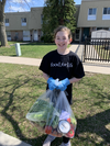 Olivia Hill, 11, distributes food in Oakville on behalf of Food for Life. Her dad, Graham Hill, is executive director of Food for Life.