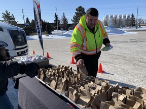 A truck driver grabs some food from Bell International Trucks in Edmonton , Alta. on Wednesday, April 1 2020.