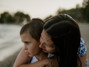 Charlotte Schwartz embraces her autistic son, Isaiah, who she says has regressed since the COVID-19 pandemic began.