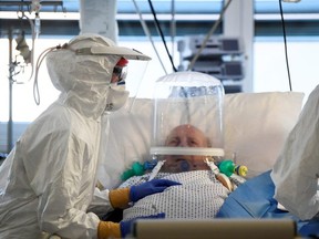 Medical staff tend to a patient suffering from the COVID-19 in the intensive care unit at the Circolo hospital in Varese, Italy, Thursday, April 9, 2020.