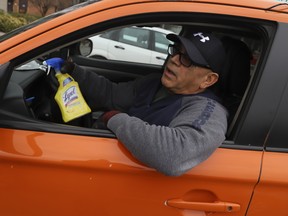 Beck Taxi driver Jafar Mirsalari uses cleaning spray as one method to try to ensure his safety and the safety of his customers during the COVID-19 pandemic.