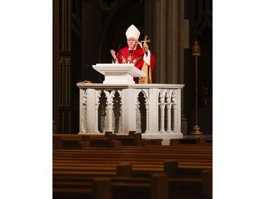 Roman Catholic Cardinal Thomas Colllins presides over Good Friday mass at St. Michael's Cathedral Basilica on Bond St. To and empty church on Good Friday on Friday April 10, 2020. Jack Boland/Toronto Sun/Postmedia Network