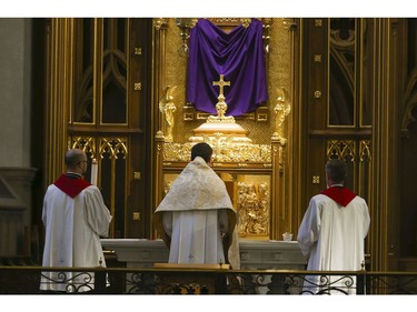 Roman Catholic Cardinal Thomas Colllins presides over Good Friday mass at St. Michael's Cathedral Basilica on Bond St. To and empty church on Good Friday on Friday April 10, 2020. Jack Boland/Toronto Sun/Postmedia Network