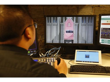 Deacon Michael Corpus checks out his camera and video angles in the basement of  St. Michael's Cathedral Basilica on Bond St. Before simulcasting the Good Friday service on Youtube and Facebook Live to those who couldn't attend mass because of COVID19 pandemic on Friday April 10, 2020. Jack Boland/Toronto Sun/Postmedia Network