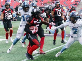 Toronto Argonauts Nelkas Kwemo, left, is pursuing a business career while playing in Toronto. Postmedia file photo