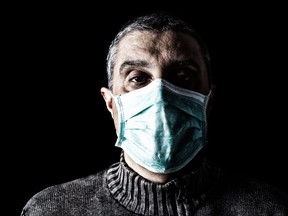 Man with surgical mask. Pandemic or epidemic and scary, fear or danger concept. Protection for biohazard like COVID-19 aka Coronavirus. Black Background