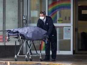 A body is removed from the Centre d'hebergement de Sainte-Dorothee in Laval, Quebec April 13, 2020. (REUTERS/Christinne Muschi)