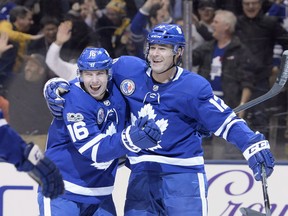 Former Maple Leaf Patrick Marleau (right) celebrates a game-winning goal with teammate Mitch Marner. (Nathan Denette/The Canadian Press)