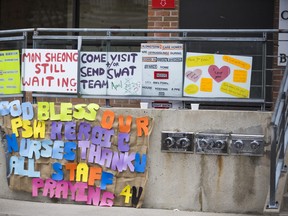 Signs of support and asking for help outside of Mon Sheong Home for the Aged in Toronto on April 26, 2020.
