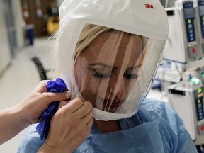 A nurse prepares to enter the room of a coronavirus disease (COVID-19) patient in the COVID ICU at the University of Washington Medical Center - Montlake during the COVID-19 outbreak in Seattle, Washington, D.C., April 24, 2020.