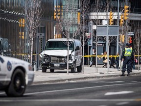 Police are seen near a damaged van in Toronto after a van mounted a sidewalk crashing into a number of pedestrians on Monday, April 23, 2018. Toronto will commemorate the second anniversary of a deadly van attack virtually due to the COVID-19 pandemic. Mayor John Tory is set to deliver a statement on YouTube this morning and an online vigil is planned for tonight.