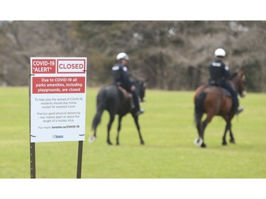 Toronto Police mounted unit and Toronto by-law enforcement officers were at the Bloor St. West entrance  High Park making sure about social distancing and telling people to move along and not gather in areas.  on Sunday April 5, 2020. Jack Boland/Toronto Sun/Postmedia Network